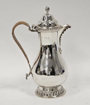 Late Victorian crested silver hot water jug, baluster-shaped and having high domed lid and