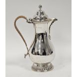 Late Victorian crested silver hot water jug, baluster-shaped and having high domed lid and