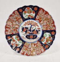 Japanese porcelain Imari fluted circular dish, 19th century, painted and gilt with a jardiniere of