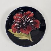 Moorcroft blue ground small circular dish in the Hibiscus pattern, marks below Potters to the Late