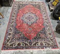 Large eastern red ground rug the central floral medallion on stylised floral field with floral