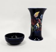 Moorcroft blue-ground Iris pattern flared cylindrical vase and a small blue trinket dish, printed