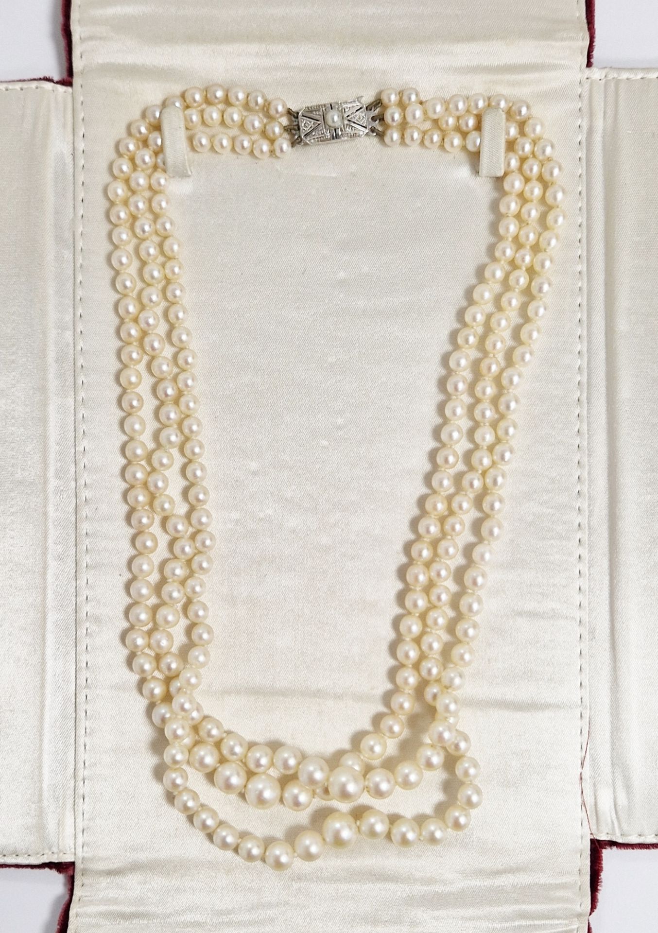 Triple string of graduated cultured pearls with white 9ct gold and pearl clasp, in Falconer's Hong