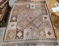 Large pink ground rug with central stepped 'X' shaped panel to single geometric border, 250cm x