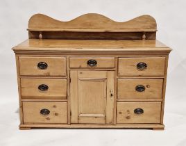 19th century pine low dresser with raised ledge back (later), seven short drawers arranged around
