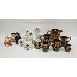 Collection of Staffordshire pottery including a group of copper lustre jugs, a two-handled loving