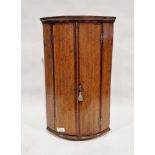 Georgian oak wall-hanging quarter round corner cupboard, the two doors opening to reveal three