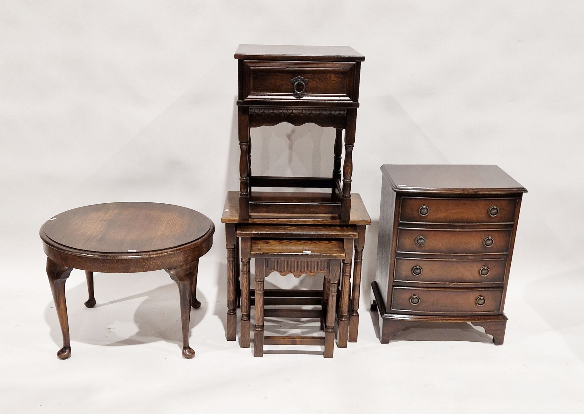 Oak nest of three occasional tables, largest 48cm high x 52cm wide x 35cm deep, a mahogany veneer