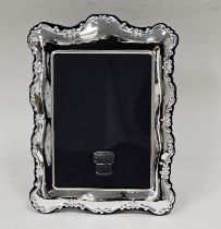 Contemporary silver photograph frame, of rectangular rocaille moulded form, backed in blue velvet