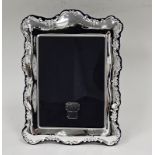 Contemporary silver photograph frame, of rectangular rocaille moulded form, backed in blue velvet