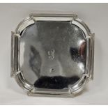 A George V silver shaped square salver, reeded border, raised on four scroll legs, approximately