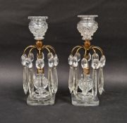 Pair of Victorian cut glass candle lustres, flowerhead drip pans above a brass column stem with