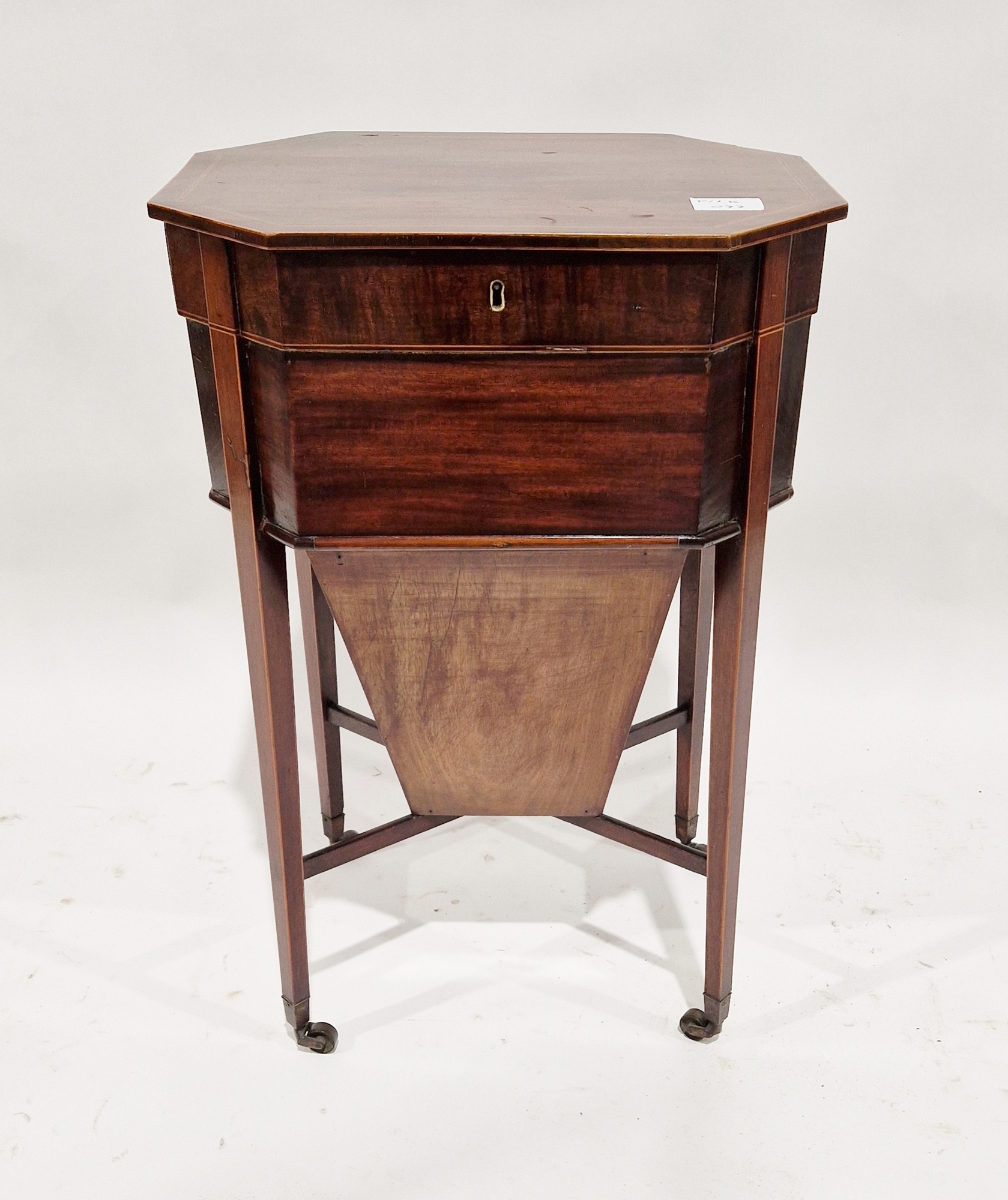 Edwardian mahogany sewing table of octagonal form with lid opening to reveal a fitted interior, with