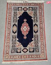 Eastern blue ground silk rug, possibly Iraq, the central floral medallion on plain field with floral