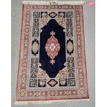 Eastern blue ground silk rug, possibly Iraq, the central floral medallion on plain field with floral