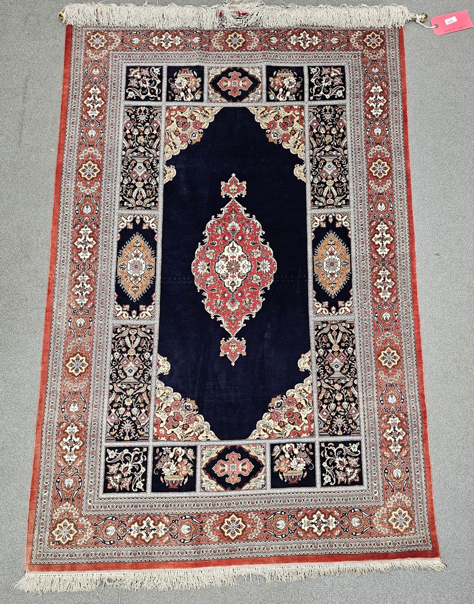 Eastern blue ground silk rug, possibly Iraq, the central floral medallion on plain field with floral