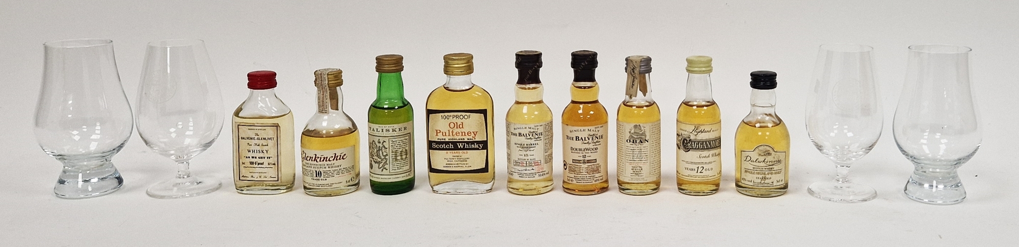 Nine miniature bottles of whisky and four tulip-shaped tasting glasses, two being Glencairn style