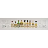 Nine miniature bottles of whisky and four tulip-shaped tasting glasses, two being Glencairn style