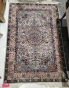 Persian style cream ground rug with central floral medallion on floral field and floral spandrels,
