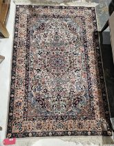 Persian style cream ground rug with central floral medallion on floral field and floral spandrels,