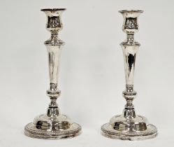 Pair white metal candlesticks, unmarked, each with bell-shaped sconce, shouldered tapering column,