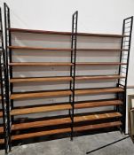 Mid century Ladderax three-section shelving unit comprising three black painted metal frames and