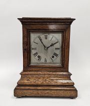 Oak cased four-glass mantel clock of rectangular form, on stepped moulded base, a 15cm square dial