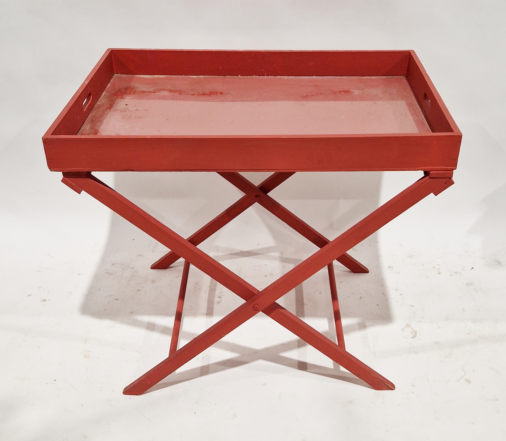 Red painted butler's tray on X-frame stand, 69cm high x 84cm wide x 61cm deep