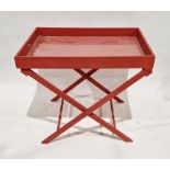 Red painted butler's tray on X-frame stand, 69cm high x 84cm wide x 61cm deep