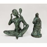 Patinated metal figure of an Eastern girl sitting cross-legged, holding up a mirror while she does