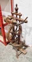 20th century spinning wheel, probably beech, on baluster tripod supports, 87.5cm high