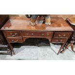 Reproduction mahogany veneer desk with central long drawer flanked by two short drawers on each