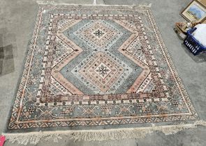 Chinese cream ground wool pile rug with two central stepped lozenge medallions, multiple geometric