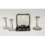 Pair of Edwardian silver candlesticks with ribbon and foliate decoration, Birmingham 1909, makers