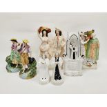 Collection of Staffordshire pottery figures including a Wesley clock face group and two further