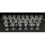 Quantity of Waterford 'Sheila' pattern wine glasses, each conical bowl panel cut, on faceted