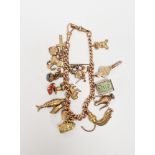 9ct rose gold curb link charm bracelet having multiple charms including jousting knight, fire