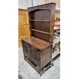 Mid 20th century oak kitchen dresser with two tier plate rack, over a two-door cupboard, 176cm