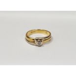 18ct gold solitaire diamond ring, the yellow and white geometric crossover setting having single