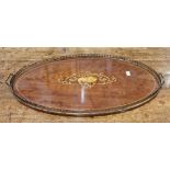 Edwardian oval mahogany tray inlaid with musical instruments and floral swags, brass handles and