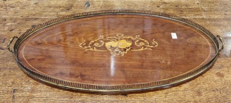 Edwardian oval mahogany tray inlaid with musical instruments and floral swags, brass handles and