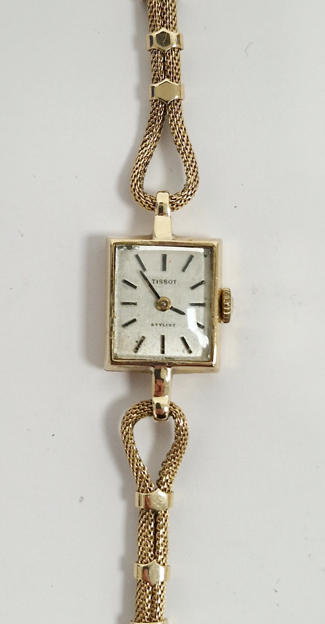 Lady's 9ct gold Tissot wristwatch with square dial, baton numerals and the fancy chain link