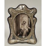 A silver mounted Art Nouveau style oval photograph frame, velvet easel back, approximately