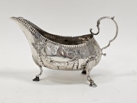 George III Irish silver sauceboat by Matthew West, Dublin (no date letter), decorated with garlands,