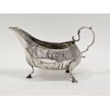 George III Irish silver sauceboat by Matthew West, Dublin (no date letter), decorated with garlands,