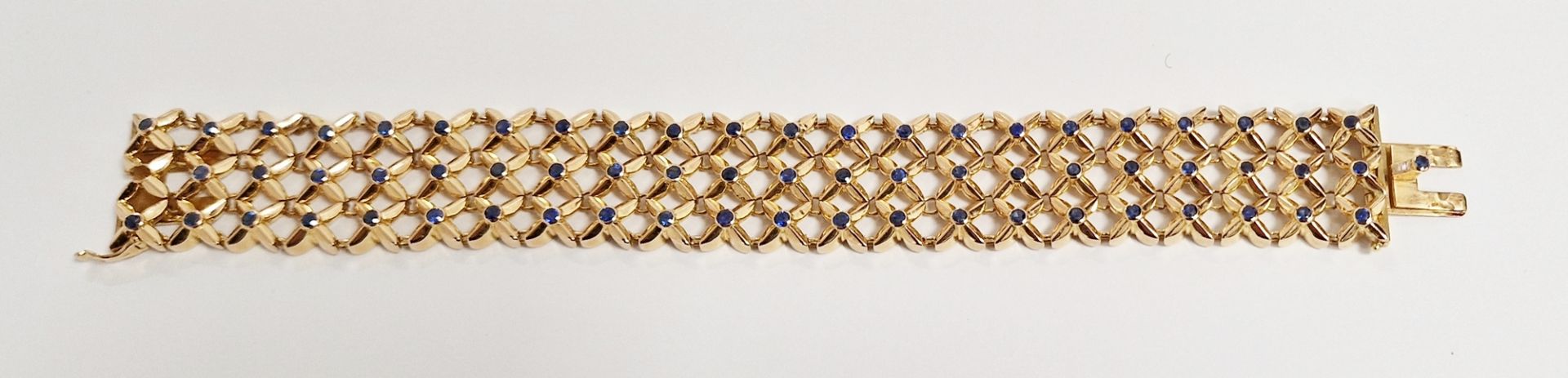 Boucheron gold and sapphire trellis-pattern bracelet, set with three rows of multiple collet set