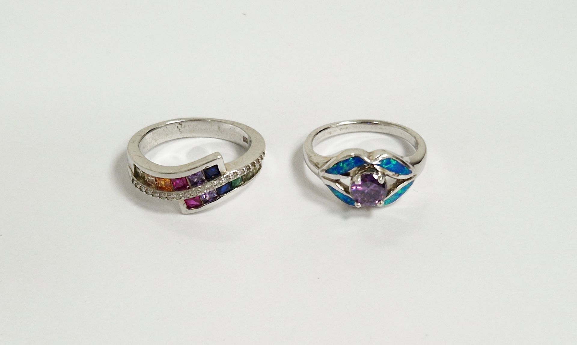 Two silver and coloured stone set rings (2)