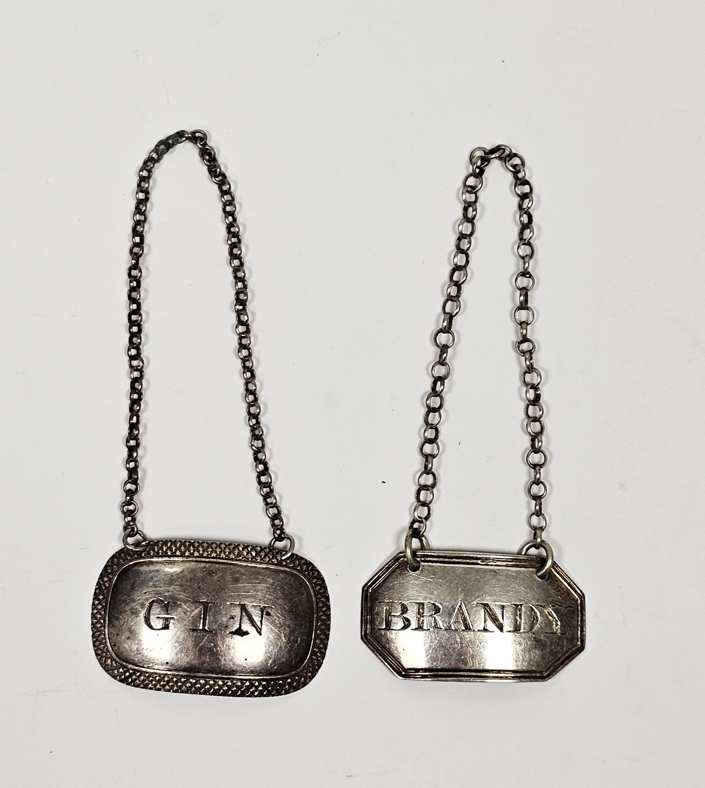 Two Georgian silver wine labels, one by Joseph Willmore, Birmingham 1820, of oval form engraved '