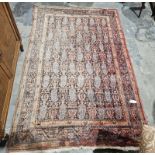 Eastern red ground rug with boteh field, multiple geometric borers (very worn and sun bleached),