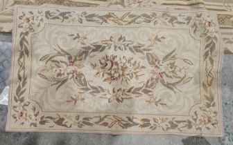 Large beige ground carpet with central floral oval medallion, floral spandrels and multiple floral